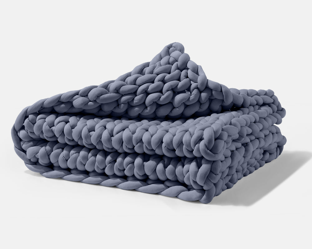 A folded Blueberry Gravity Weighted Chunky Knit Blanket - #color_blueberry