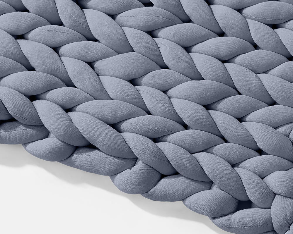 Angled closeup on the texture of the Blueberry Gravity Weighted Chunky Knit Blanket - #color_blueberry