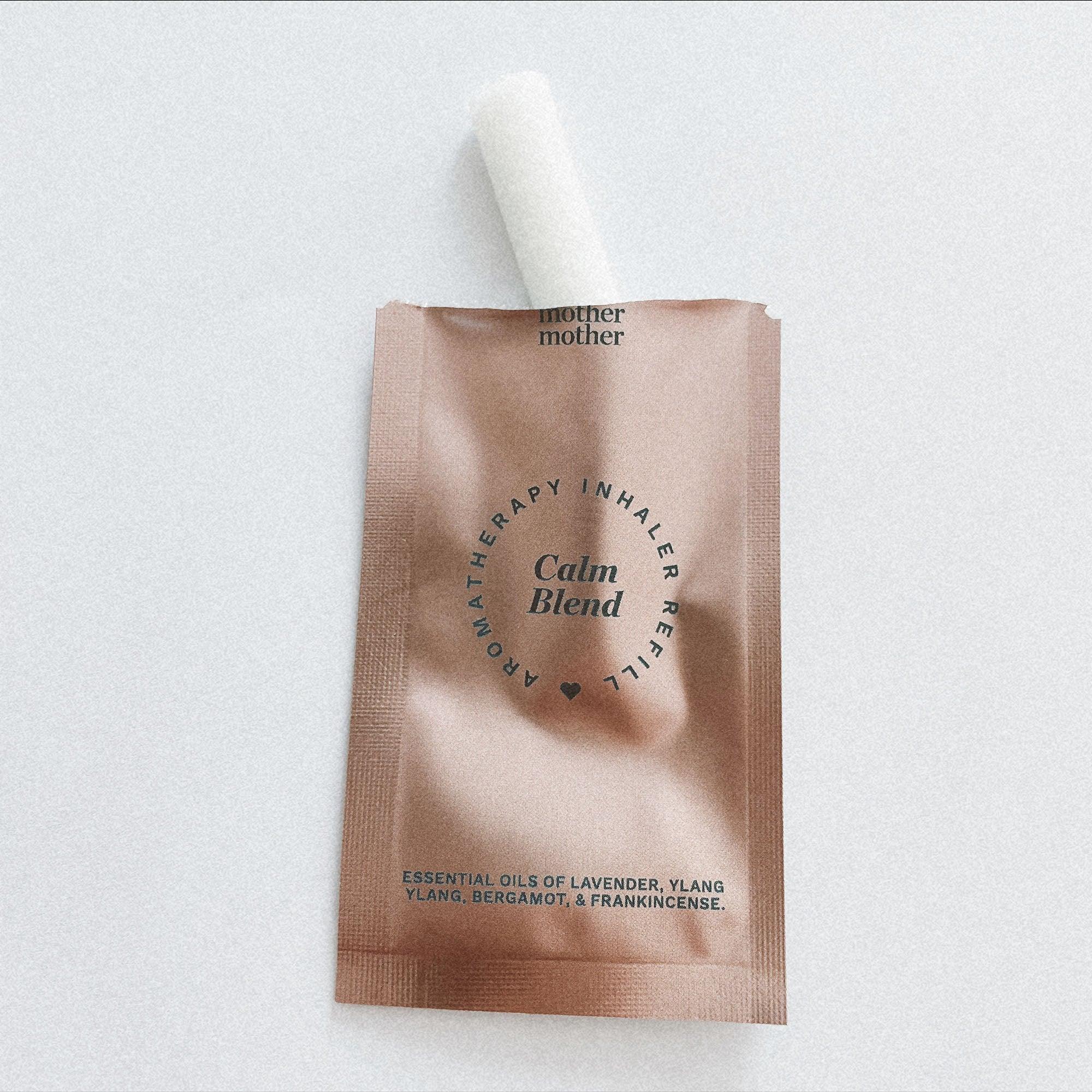 Pink pouch with a calm inhaler refill wick sticking out.
